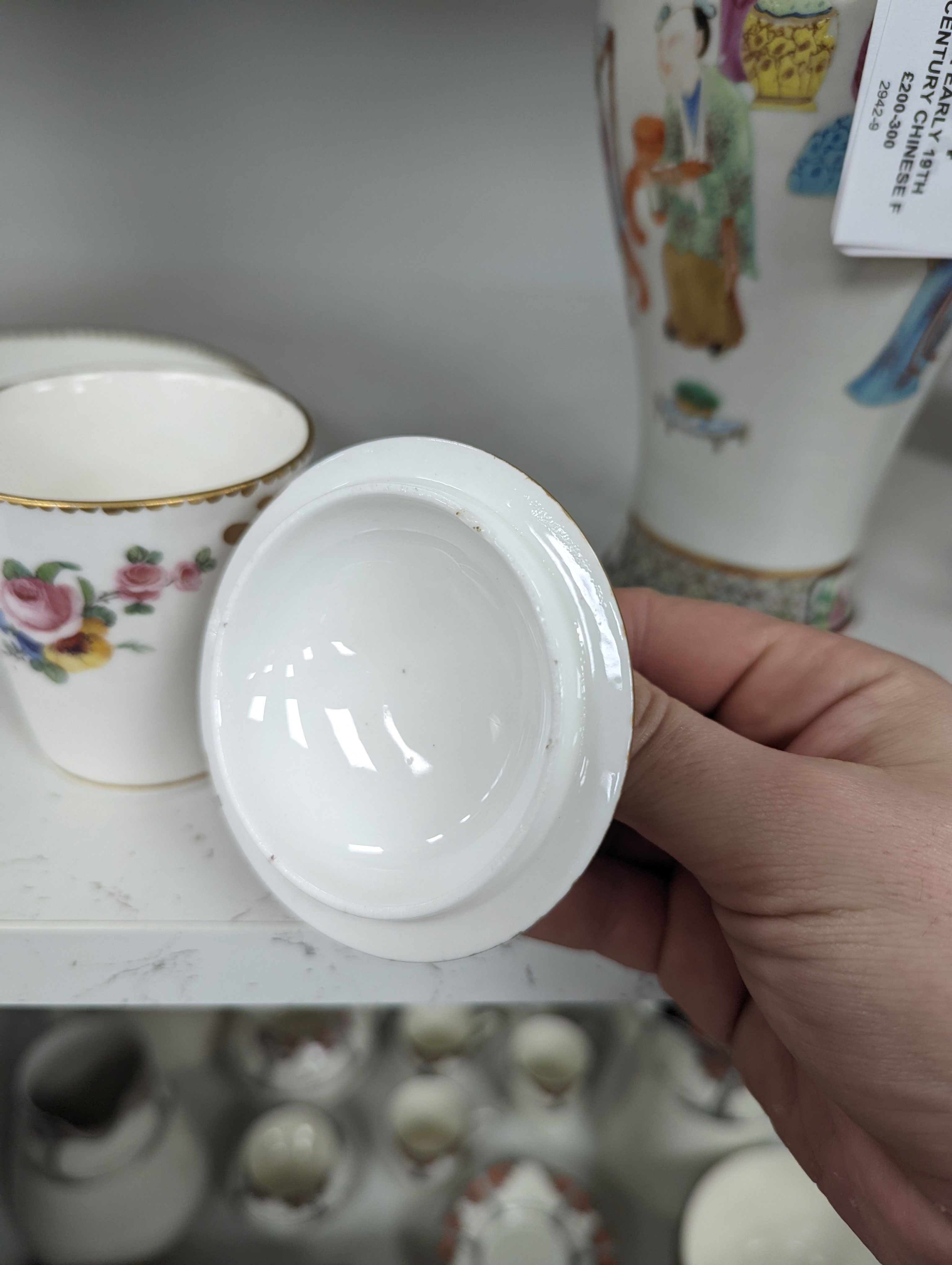 A Sevres tapering cup with entwined handle and cover and stand painted with flowers, date code for 1780, painters mark for Le Bel jnr., square incised marks, height 10.5cm